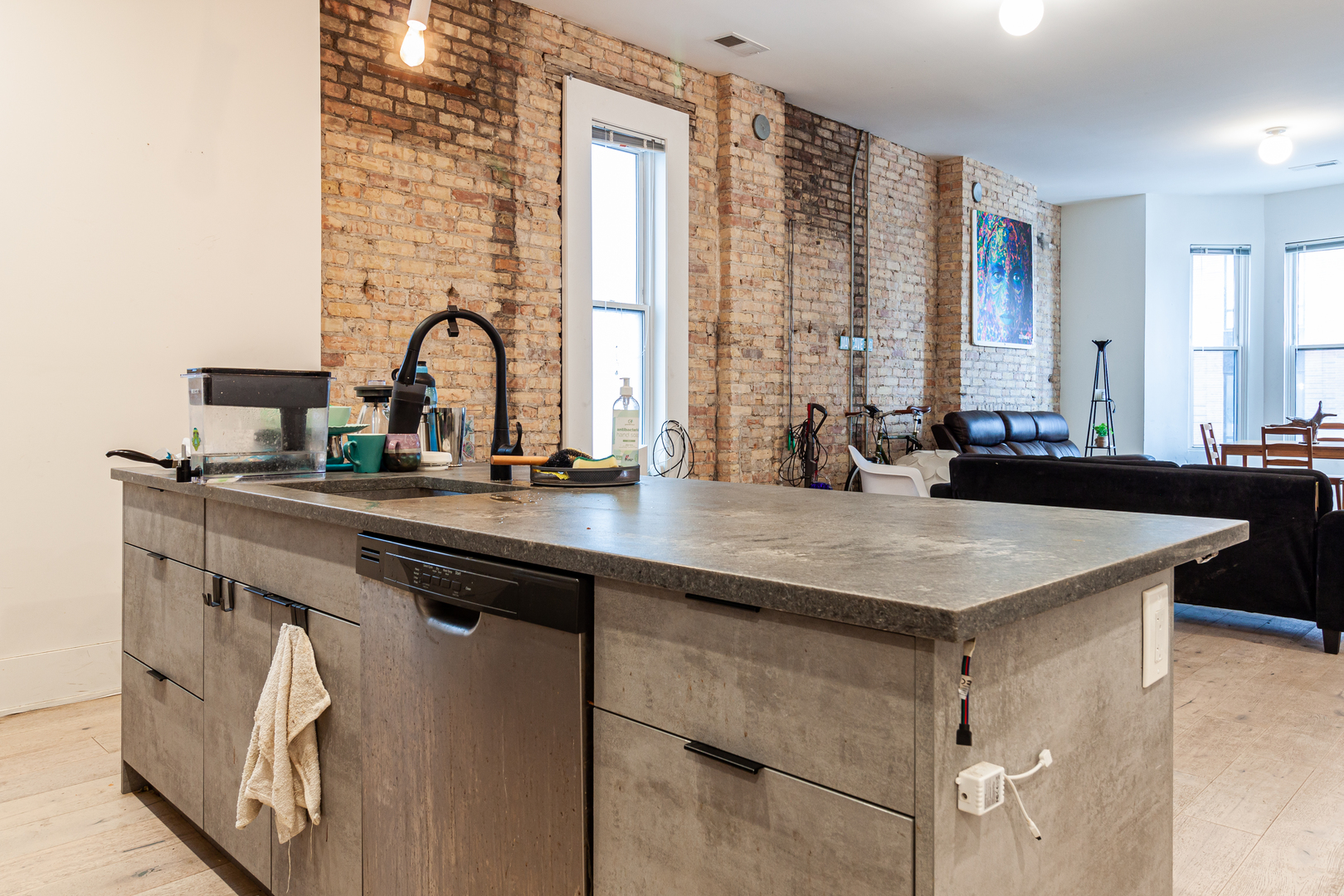 324 South Racine Avenue, Unit 4N Chicago, IL 60607 - Photo 3 of 9 a kitchen with a sink a counter and a dining table