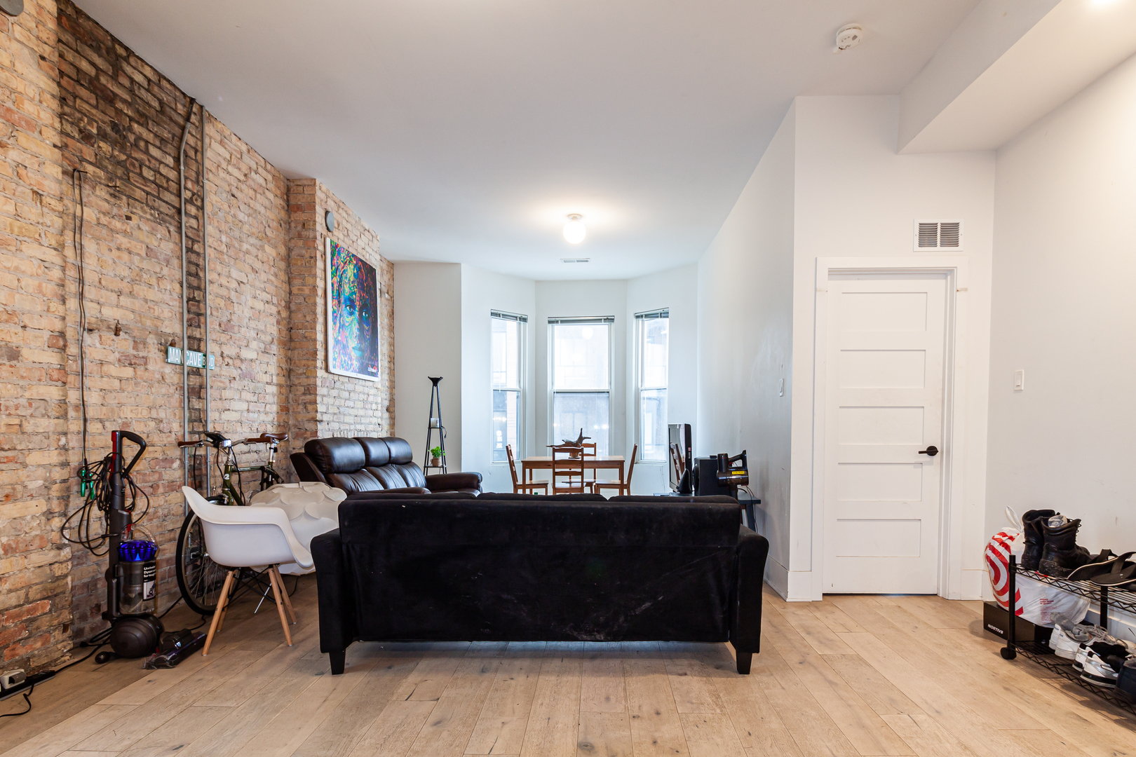 324 South Racine Avenue, Unit 4N Chicago, IL 60607 - Photo 4 of 9 a living room with furniture and a large mirror next to a window