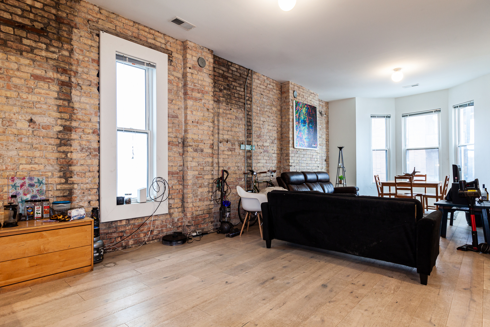 324 South Racine Avenue, Unit 4N Chicago, IL 60607 - Photo 5 of 9 a living room with furniture and large windows