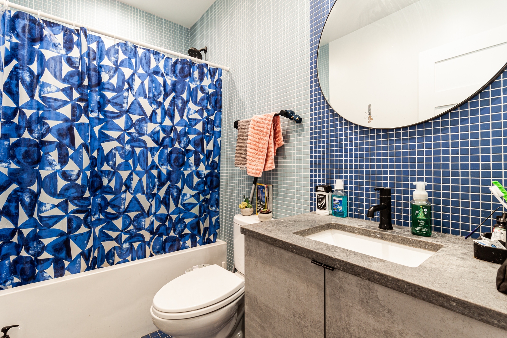 324 South Racine Avenue, Unit 4N Chicago, IL 60607 - Photo 7 of 9 a bathroom with a granite countertop toilet sink and mirror