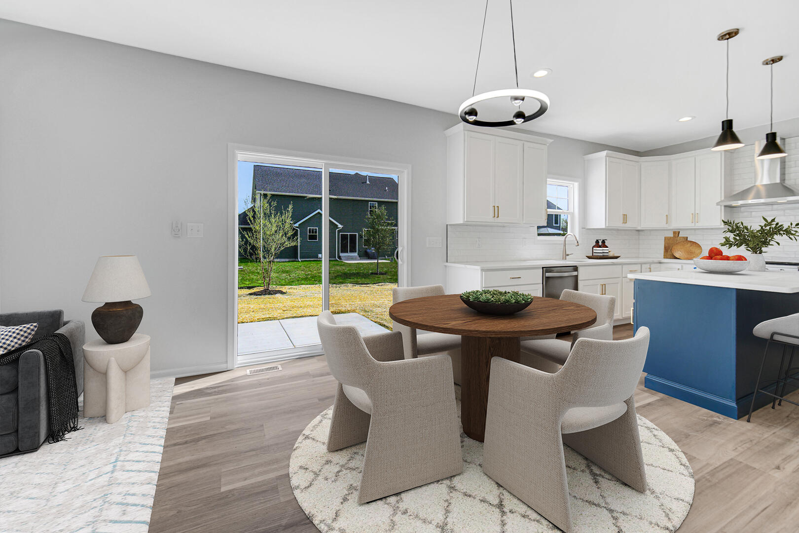 708 Druim Trail Crown Point, IN 46307 - Photo 8 of 27 a kitchen with stainless steel appliances granite countertop a sink a stove a dining table and chairs with wooden floor