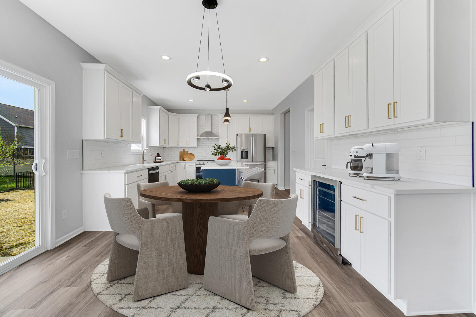 708 Druim Trail Crown Point, IN 46307 - Photo 9 of 27 a kitchen with a dining table chairs stainless steel appliances and cabinets