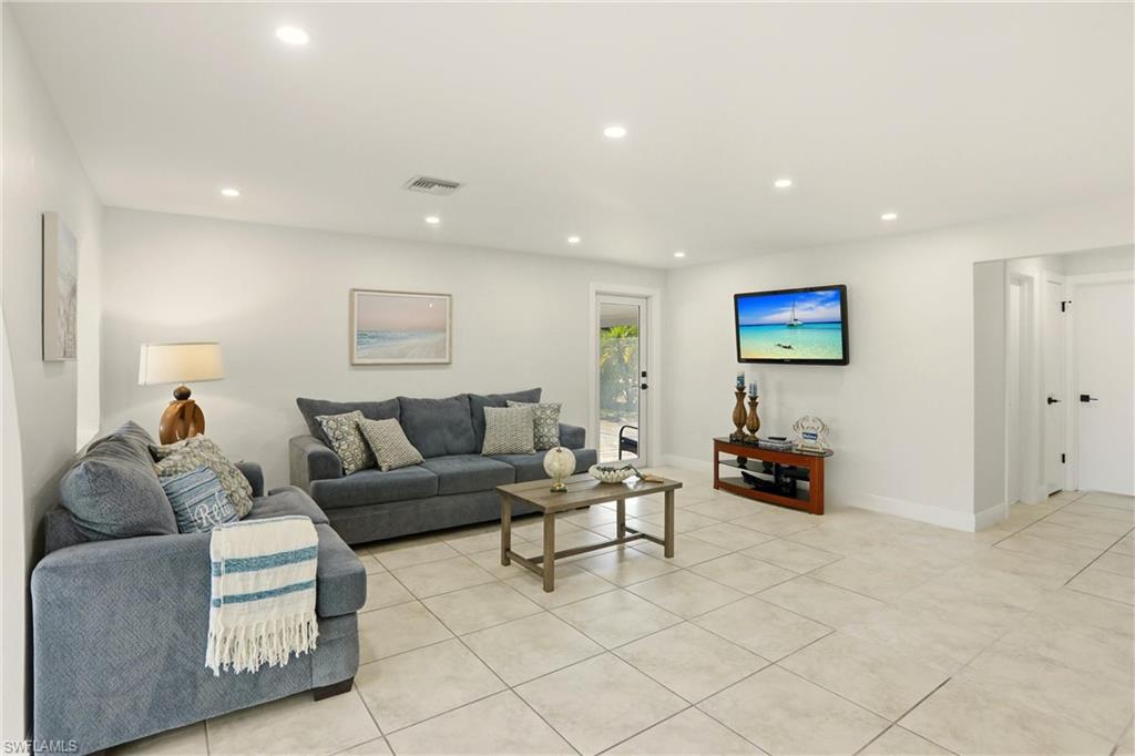 339 Landmark Street Marco Island, FL 34145 - Photo 4 of 50 Living room featuring recessed lighting and light tile patterned flooring