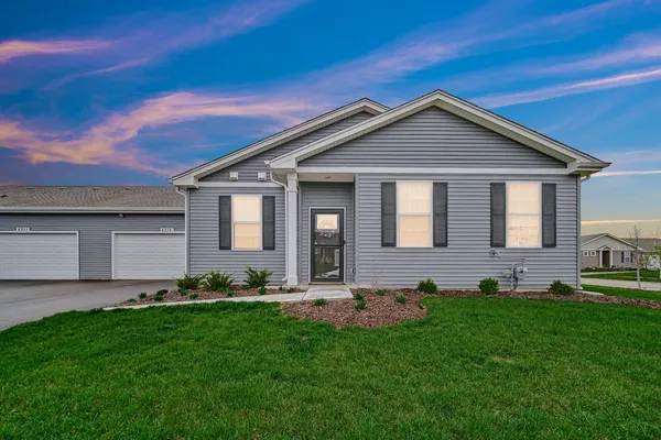 a front view of house with yard and green space