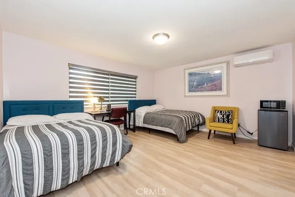 a bedroom with a bed a couch and a window