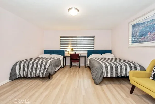 a bedroom with two beds and a couch