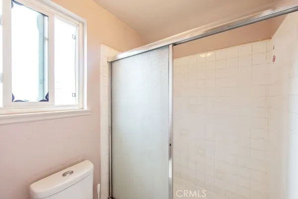 a bathroom with a shower curtain and a window