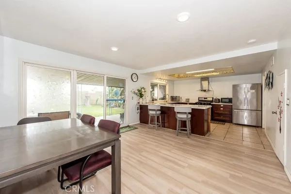a open kitchen with stainless steel appliances granite countertop a stove refrigerator and cabinets