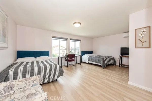 a bedroom with bed and a large window