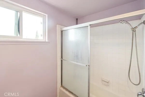 a bathroom with a glass shower door