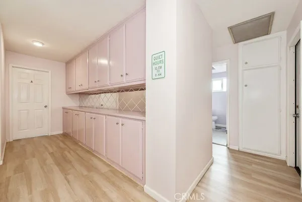 a view of a kitchen with white cabinets