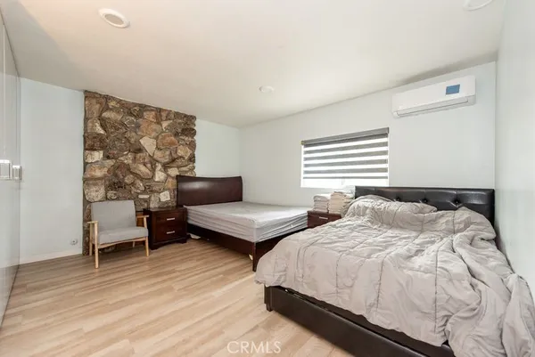 a bedroom with two beds and a couch