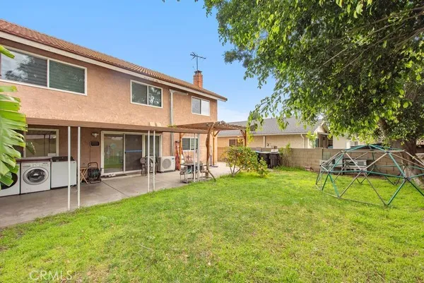 a view of a house with backyard porch and sitting area