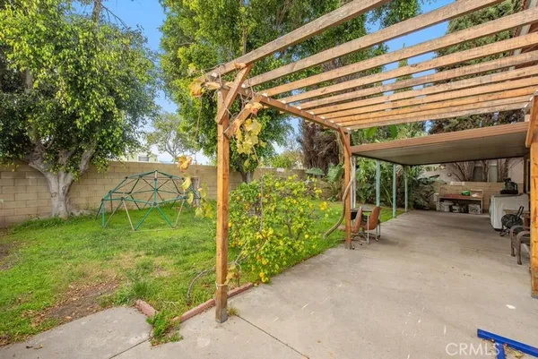 a view of a patio with a table and chairs under an umbrella