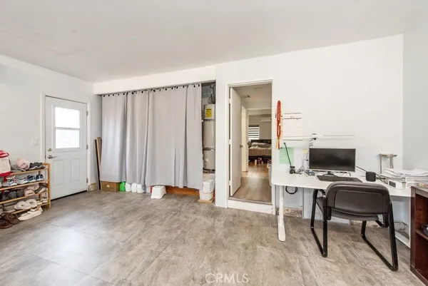 a view of a livingroom with workspace and a window