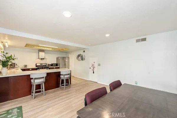a kitchen with stainless steel appliances granite countertop a stove and a wooden floors