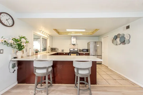 a kitchen with a dining table and chairs