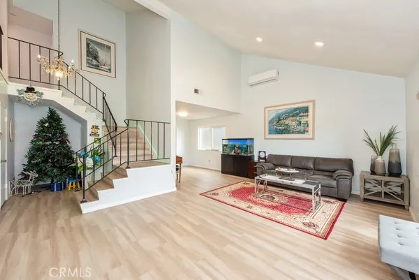 a living room with furniture and a potted plant
