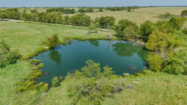 a view of a green field with an ocean view