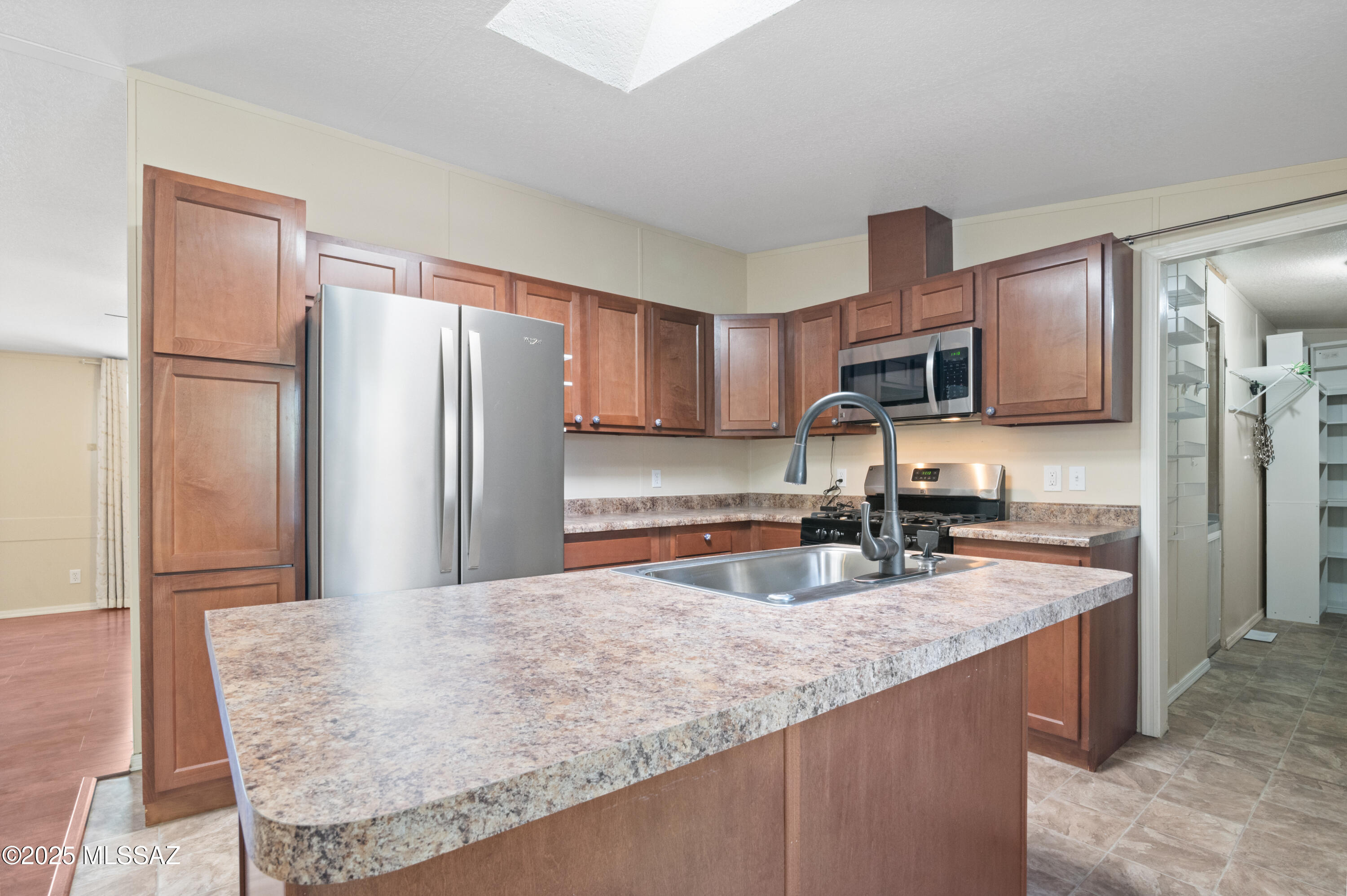 6205 East Rough Rock Drive Tucson, AZ 85756 - Photo 1 of 30 a kitchen with stainless steel appliances granite countertop a refrigerator a stove and a sink