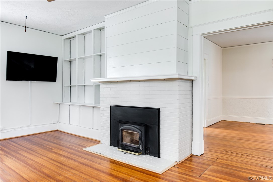 4604 Brook Road Richmond, VA 23227 - Photo 7 of 38 a living room with a fireplace and a flat screen tv