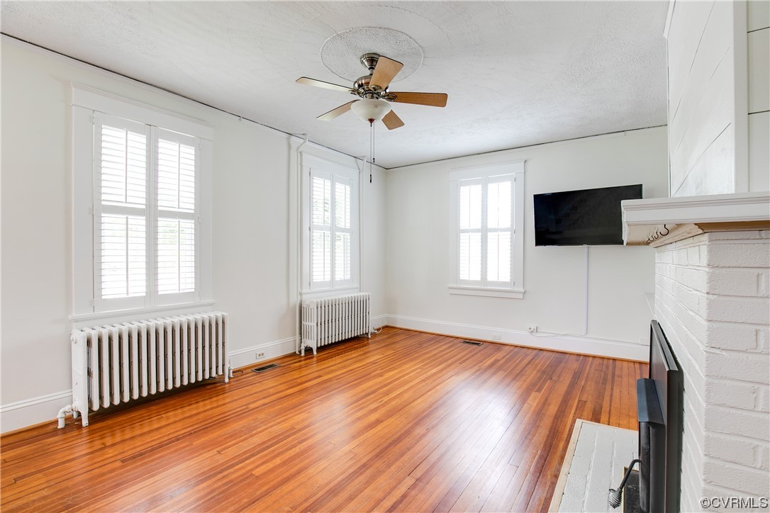 4604 Brook Road Richmond, VA 23227 - Photo 8 of 38 wooden floor in an empty room with a window and a flat screen tv