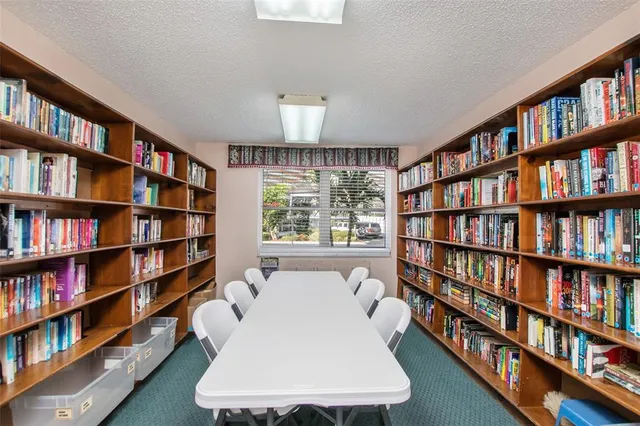 a living room with a book shelf and a book shelf