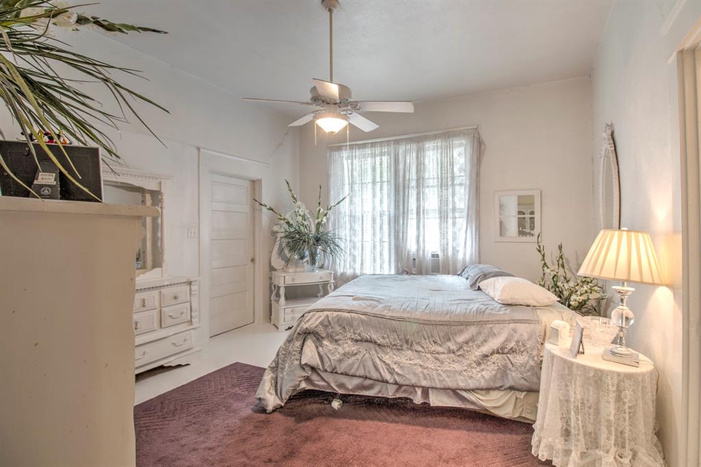 101 East Reed Trenton, TX 75490 - Photo 11 of 27 a bedroom with a bed and a chandelier