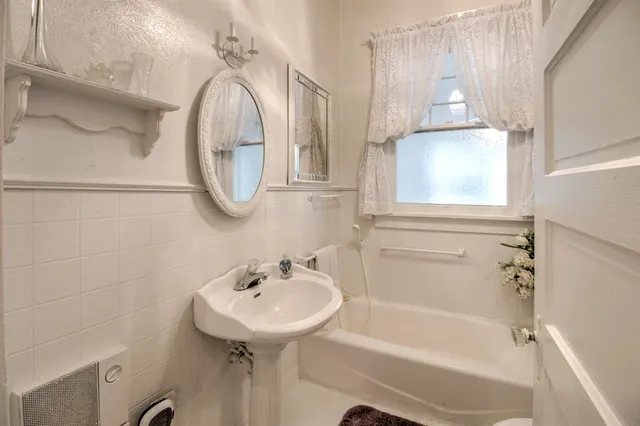 a bathroom with a sink a mirror and a bathtub