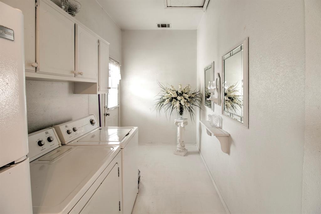 101 East Reed Trenton, TX 75490 - Photo 18 of 27 a view of washer and dryer with kitchen in the background