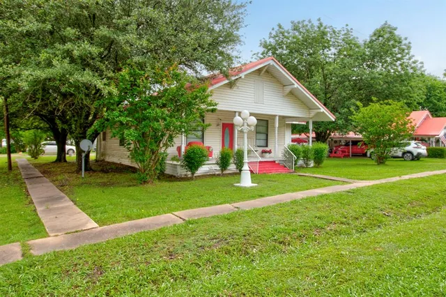 a front view of house with yard and green space
