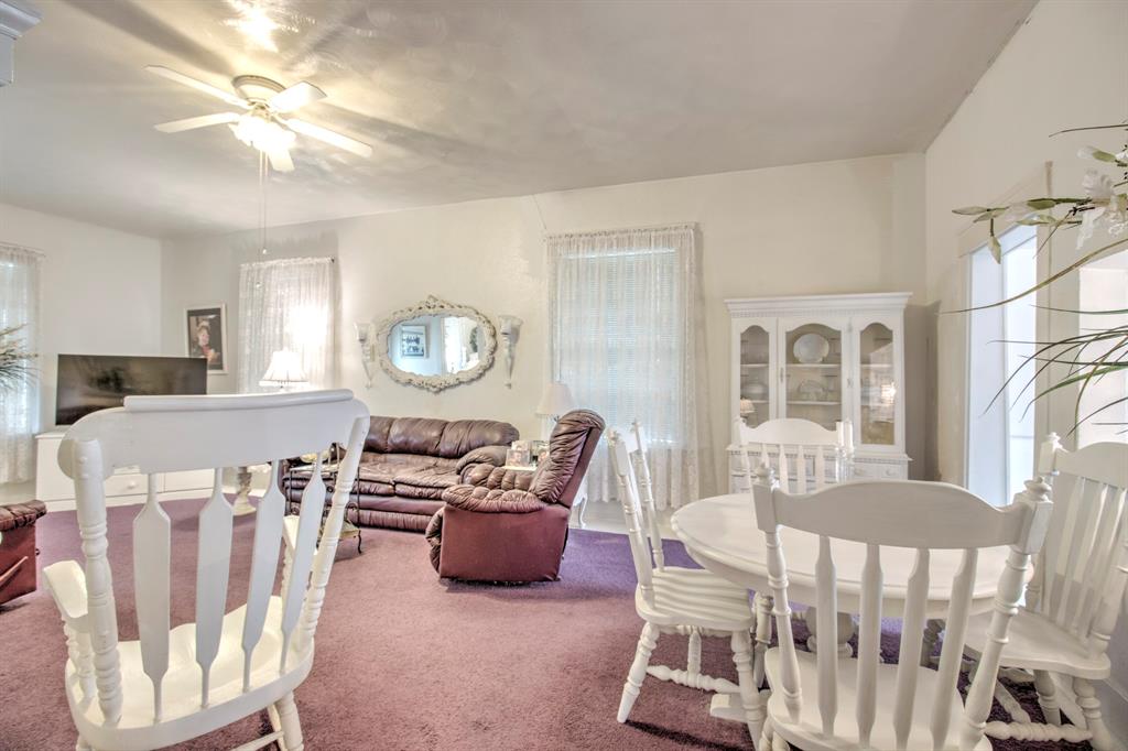 101 East Reed Trenton, TX 75490 - Photo 8 of 27 a living room with furniture a clock and a chandelier