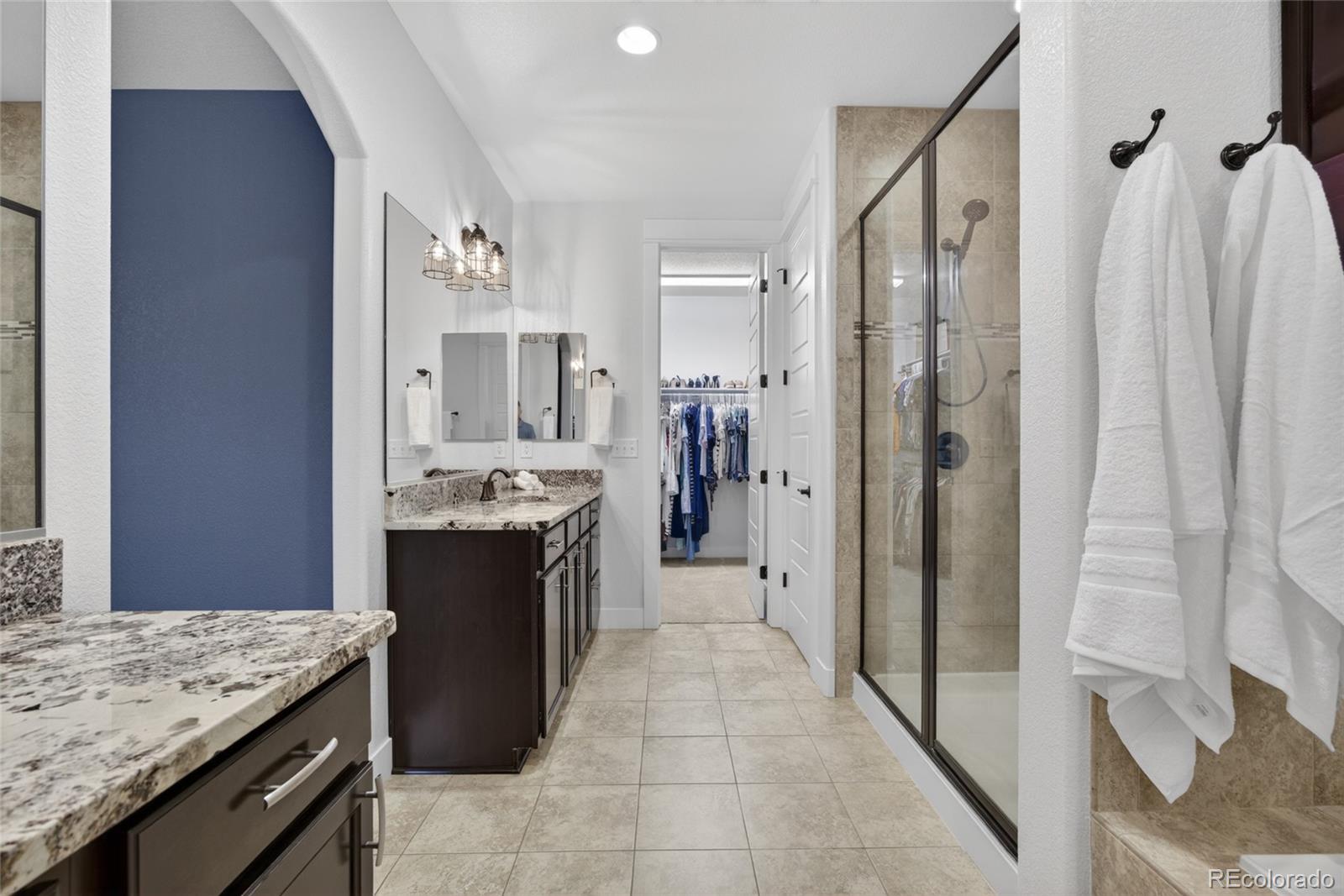 20554 East Shady Ridge Road Parker, CO 80134 - Photo 24 of 49 a large bathroom with a granite countertop shower a sink and a mirror