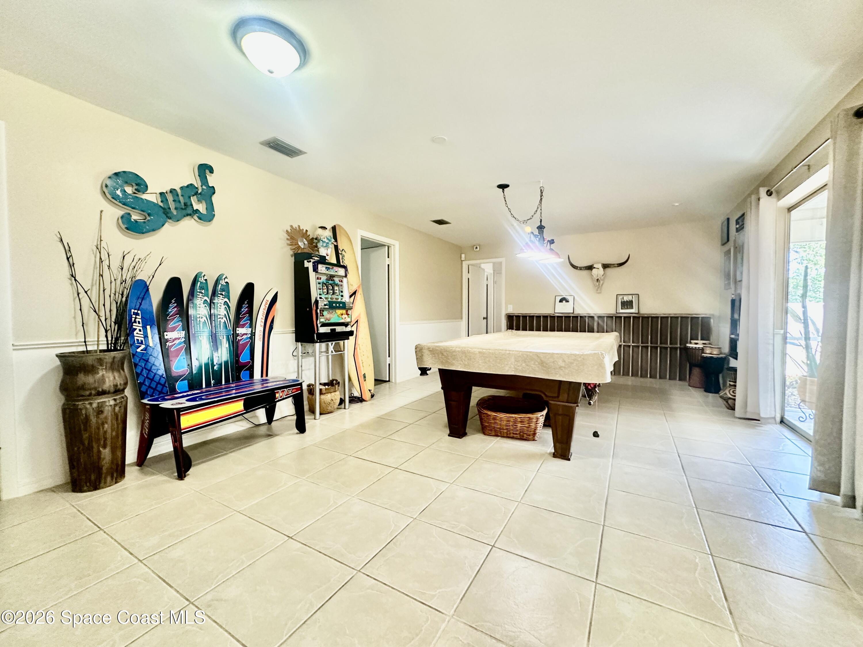 410 Surf Road Melbourne Beach, FL 32951 - Photo 11 of 29 a living room with furniture and flat screen tv