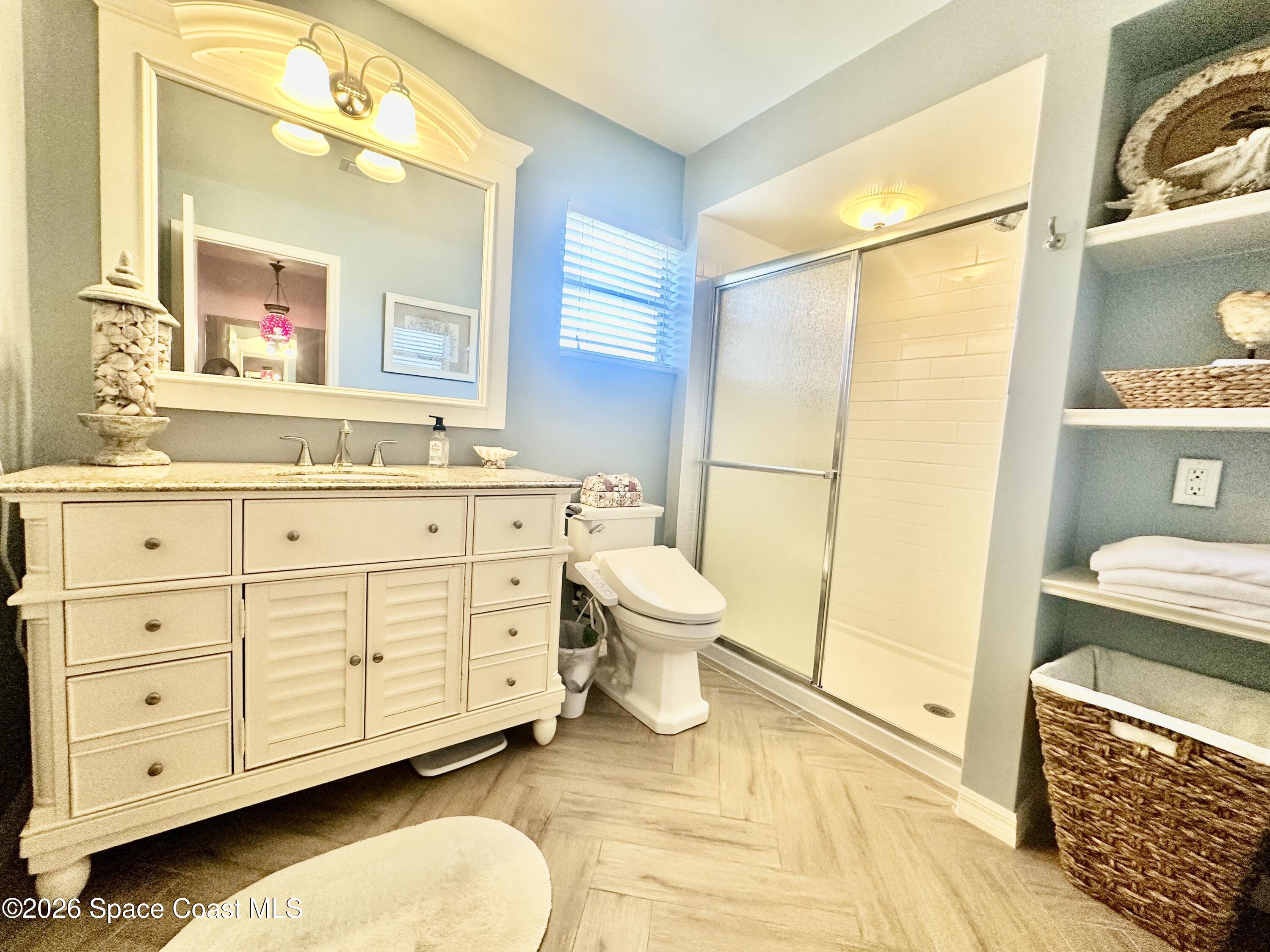 410 Surf Road Melbourne Beach, FL 32951 - Photo 23 of 29 a bathroom with a sink a toilet and shower