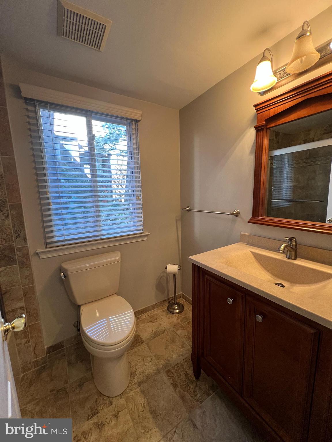 1701 Mountainview Drive, Unit 1701 Chesterbrook, PA 19087 - Photo 12 of 16 a bathroom with a toilet sink and mirror