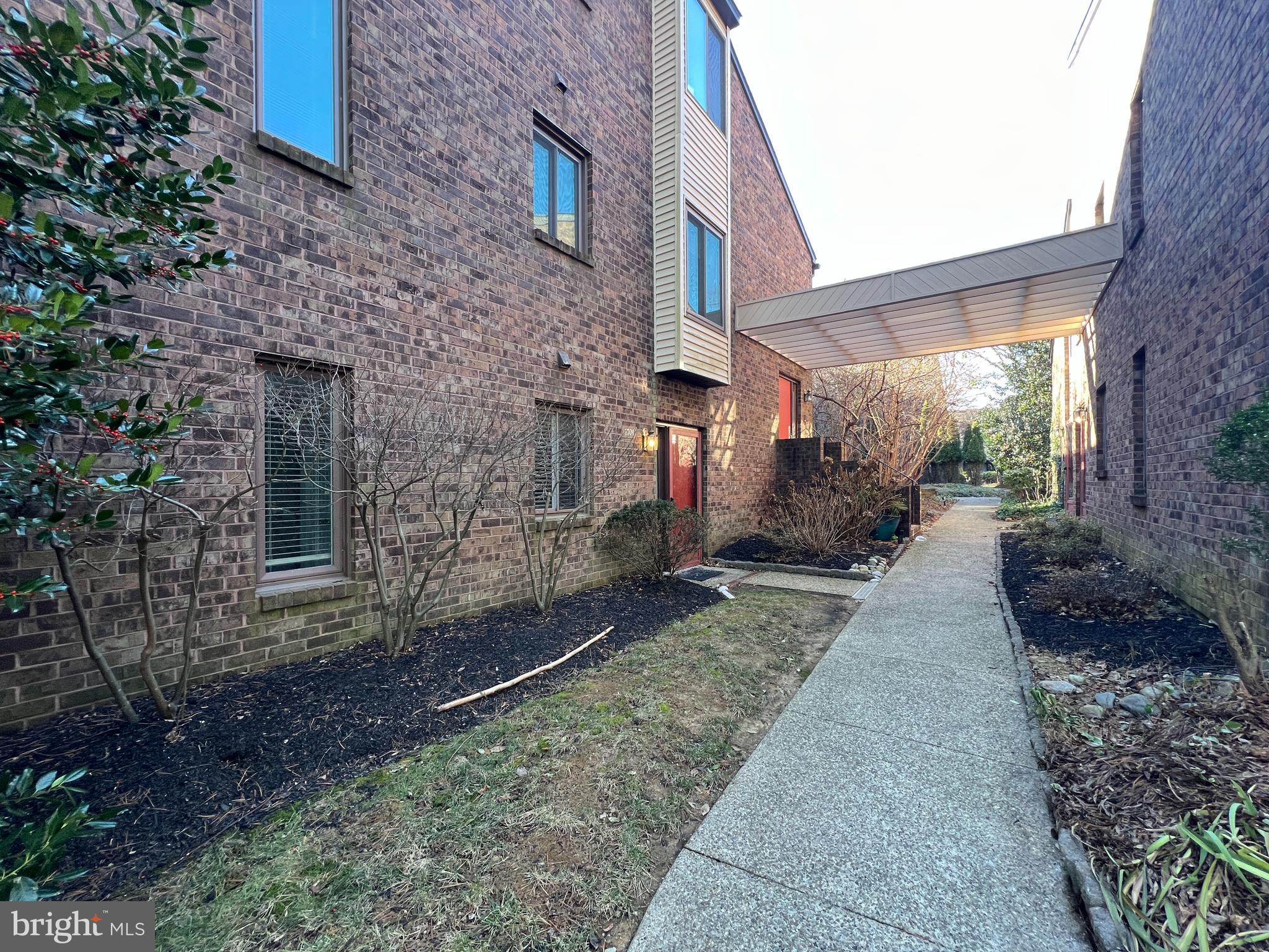 1701 Mountainview Drive, Unit 1701 Chesterbrook, PA 19087 - Photo 2 of 16 a pathway of a house with backyard and garden