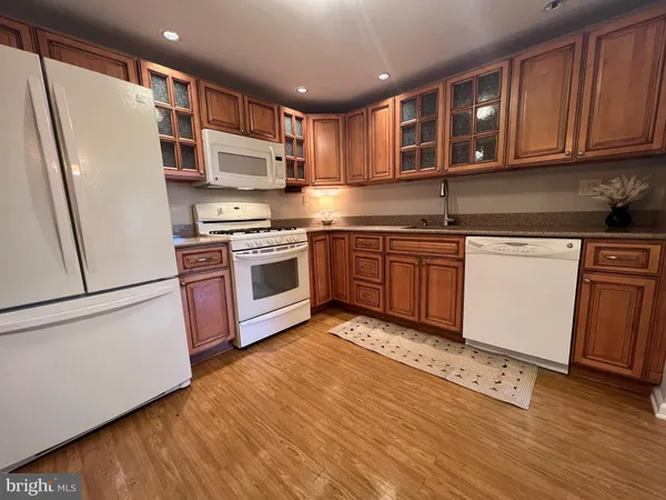 a kitchen with stainless steel appliances granite countertop a refrigerator sink and cabinets