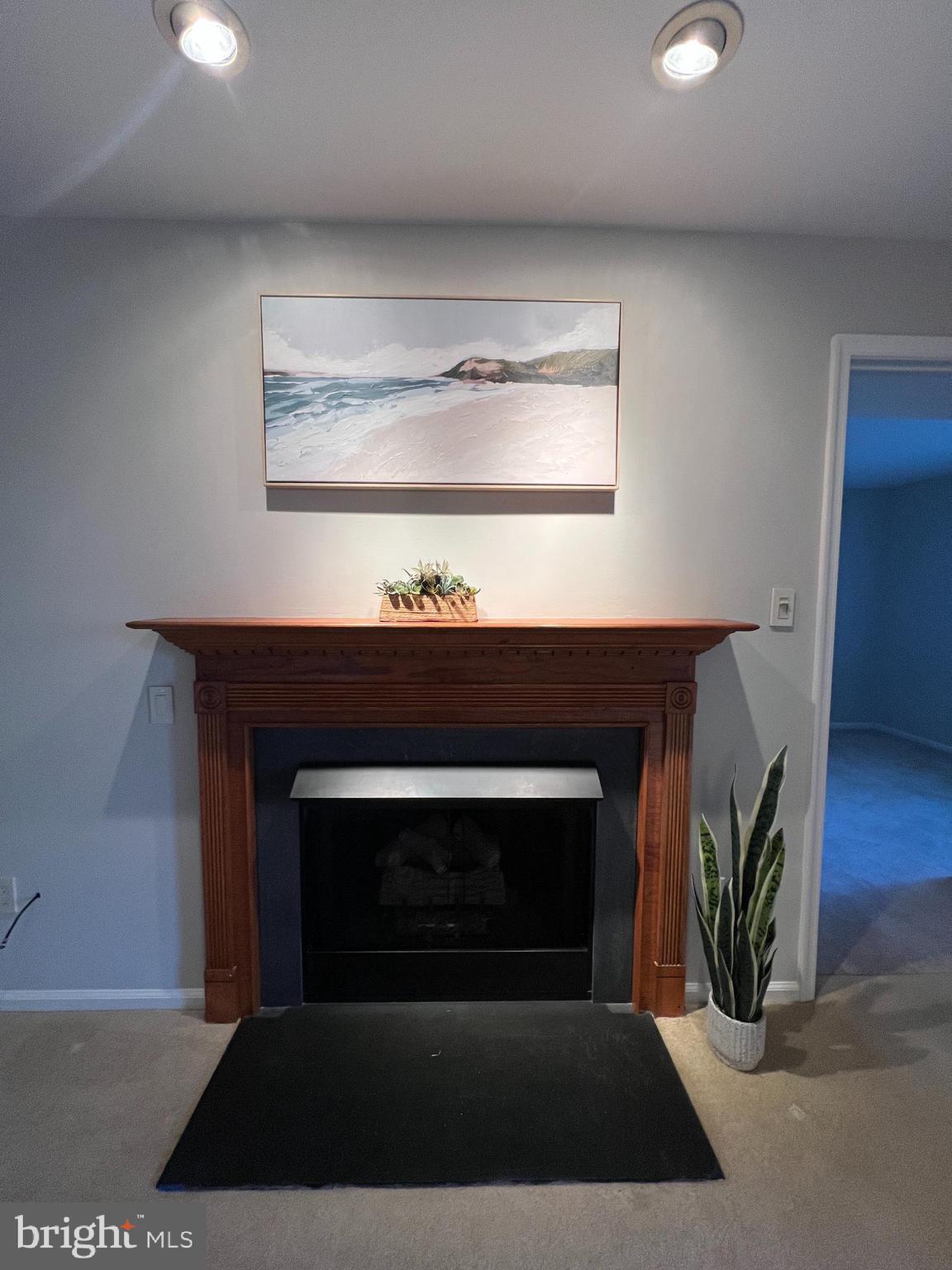 1701 Mountainview Drive, Unit 1701 Chesterbrook, PA 19087 - Photo 10 of 16 a living room with a fireplace and a window