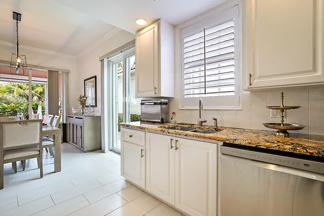 a kitchen with a sink cabinets and window