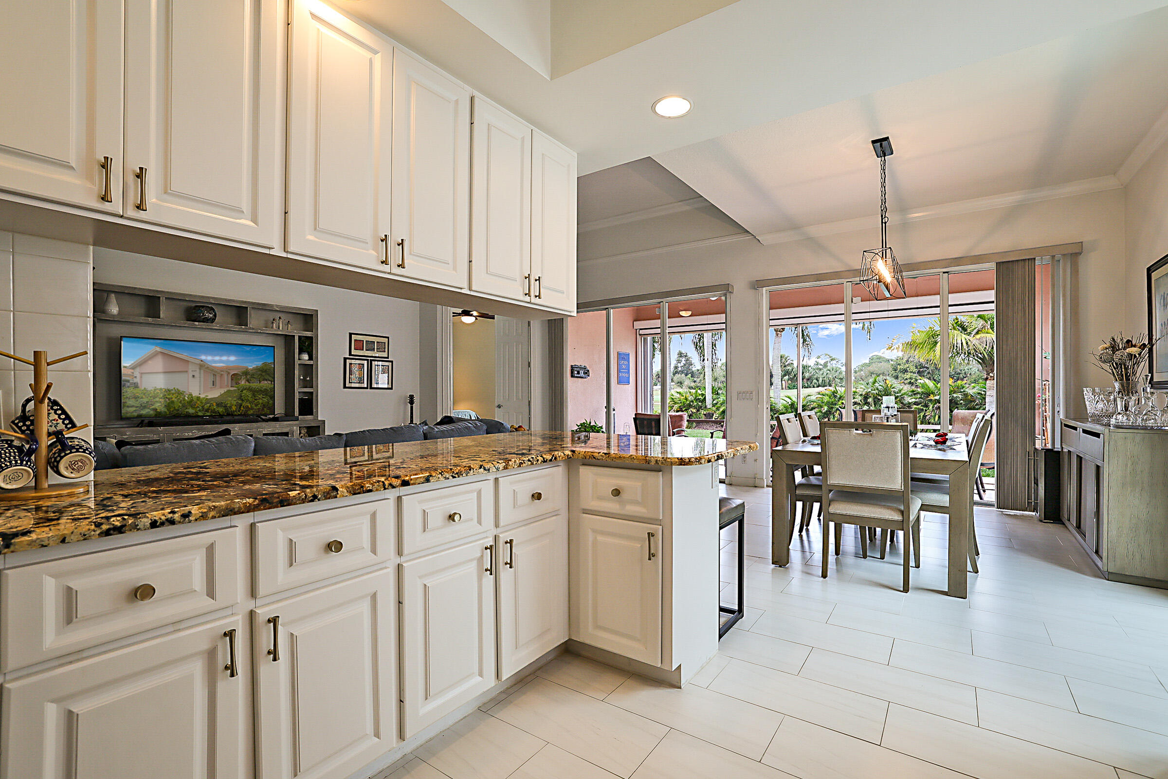 9520 Southwest Wedgewood Lane Stuart, FL 34997 - Photo 14 of 53 a kitchen with granite countertop white cabinets and white appliances