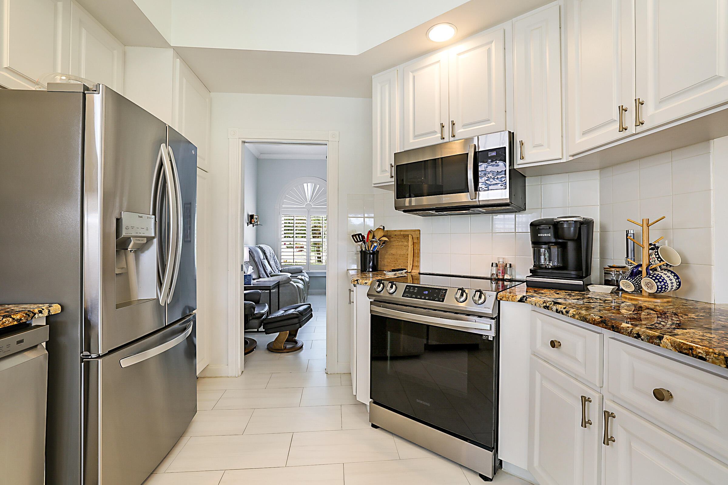 9520 Southwest Wedgewood Lane Stuart, FL 34997 - Photo 17 of 53 a kitchen with stainless steel appliances granite countertop a refrigerator stove a sink and dishwasher