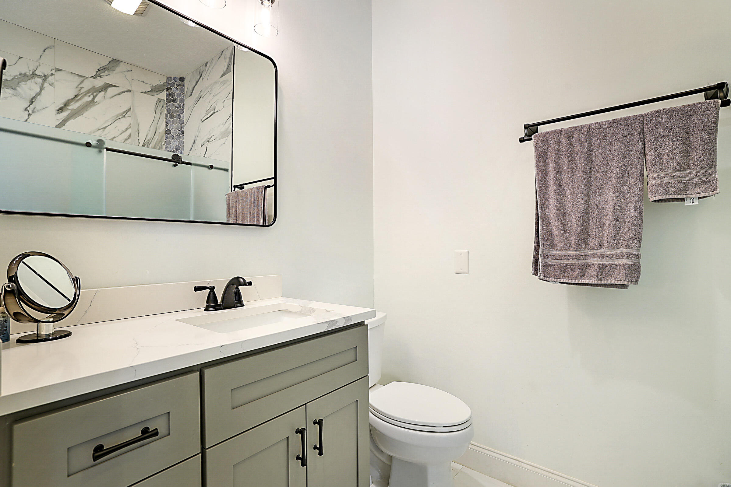 9520 Southwest Wedgewood Lane Stuart, FL 34997 - Photo 25 of 53 a bathroom with a toilet sink and mirror