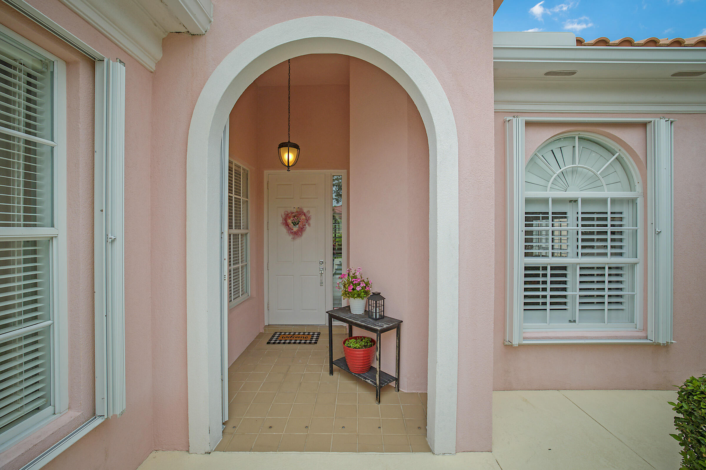 9520 Southwest Wedgewood Lane Stuart, FL 34997 - Photo 3 of 53 a front view of a house with many windows