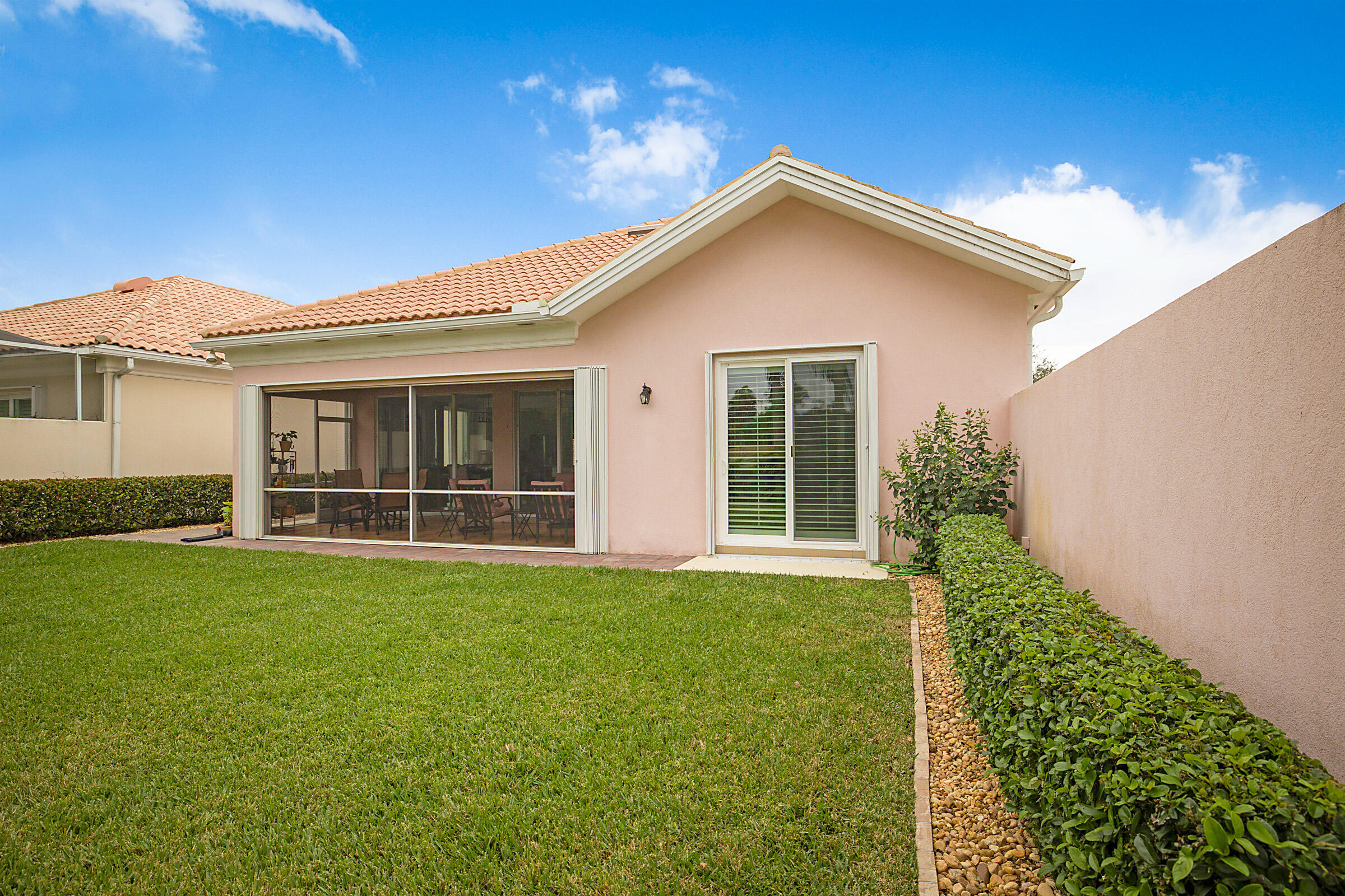 9520 Southwest Wedgewood Lane Stuart, FL 34997 - Photo 43 of 53 a front view of a house with a yard