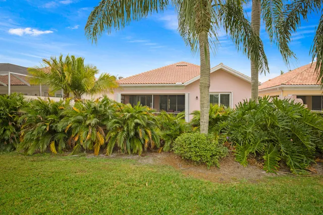 an aerial view of ocean and residential houses with outdoor space