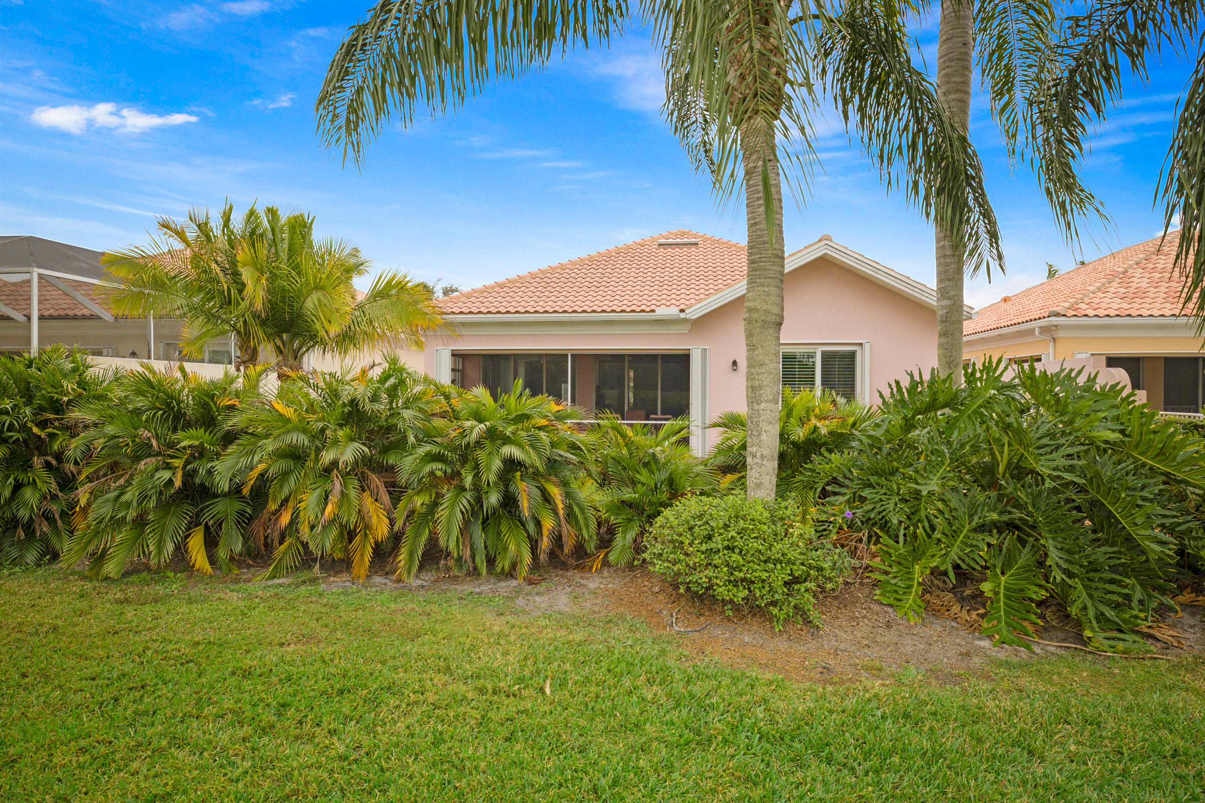 9520 Southwest Wedgewood Lane Stuart, FL 34997 - Photo 44 of 53 a front view of a house with a garden