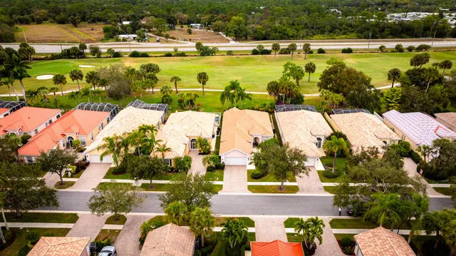 an aerial view of residential houses with outdoor space and lake view