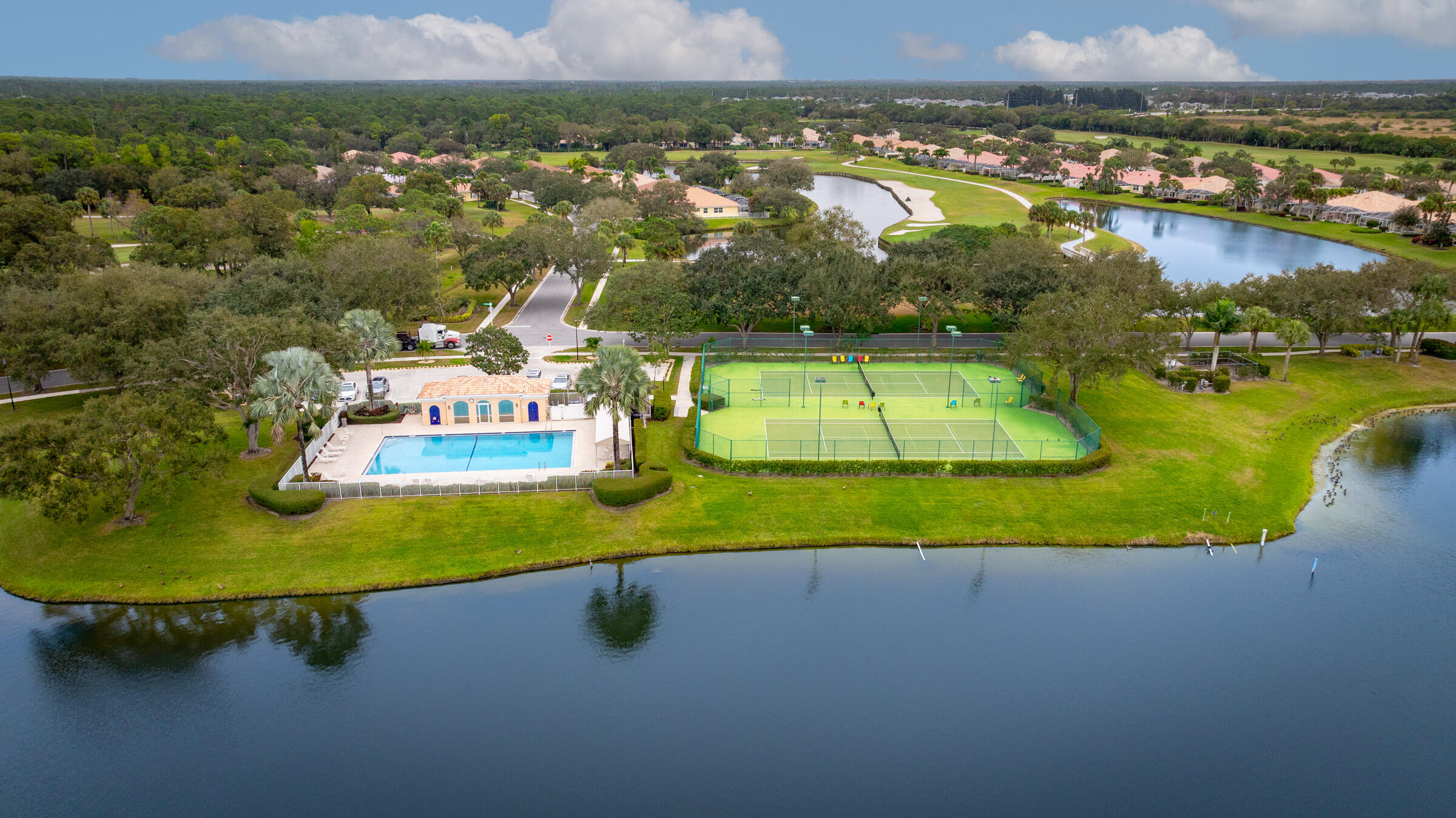 9520 Southwest Wedgewood Lane Stuart, FL 34997 - Photo 48 of 53 an aerial view of residential houses with outdoor space and lake view