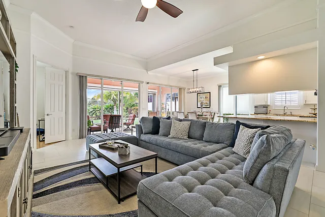 a living room with furniture ceiling fan and a window
